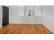 Hardwood floor bedroom with ample natural light coming from a bank of three windows at 165 Breakspear Ln, Fayetteville, GA 30214