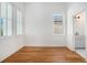 Bright bedroom featuring hardwood floors and an en-suite bathroom with white vanity at 165 Breakspear Ln, Fayetteville, GA 30214