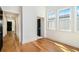 Bright bedroom featuring hardwood floors and multiple windows with natural light at 165 Breakspear Ln, Fayetteville, GA 30214