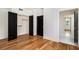 Bright bedroom featuring hardwood floors, closet, and adjacent bathroom with white herringbone tile at 165 Breakspear Ln, Fayetteville, GA 30214