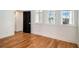 Bright bedroom featuring hardwood floors and windows with natural light at 165 Breakspear Ln, Fayetteville, GA 30214