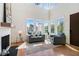Bright living room with soaring ceilings, large windows, and a cozy seating area at 165 Breakspear Ln, Fayetteville, GA 30214