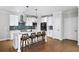 Bright kitchen featuring white cabinets, hardwood floors, a center island, and modern appliances at 185 Bellehaven Dr, Woodstock, GA 30188