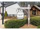 Community nature trail sign with beautiful landscaping and shrubbery in front of townhomes at 185 Bellehaven Dr, Woodstock, GA 30188