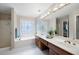 Bright bathroom featuring double vanity, soaking tub, separate shower, and decorative window at 4651 Oakleigh Manor Dr, Powder Springs, GA 30127