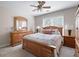 Bedroom with a wooden bed frame, ceiling fan, and a window that provides natural light at 4651 Oakleigh Manor Dr, Powder Springs, GA 30127