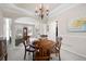 Cozy dining room with classic decor including crown molding, chair rail and warm natural light at 4651 Oakleigh Manor Dr, Powder Springs, GA 30127