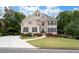 Charming two-story home with a combination of stone and beige siding and well-manicured landscaping at 4651 Oakleigh Manor Dr, Powder Springs, GA 30127