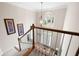 Foyer view from the staircase showcasing natural light, hardwood floors and an elegant chandelier at 4651 Oakleigh Manor Dr, Powder Springs, GA 30127