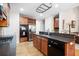 A traditional kitchen features wood cabinets, granite countertops, stainless steel appliances, and hardwood floors at 4651 Oakleigh Manor Dr, Powder Springs, GA 30127