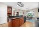 Open kitchen featuring granite countertops, wood cabinetry, and a breakfast area with lots of natural light at 4651 Oakleigh Manor Dr, Powder Springs, GA 30127