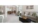Spacious living room features neutral paint, plush carpeting, natural light and views into the dining room at 4651 Oakleigh Manor Dr, Powder Springs, GA 30127