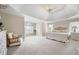 Spacious main bedroom features a tray ceiling, ceiling fan, sitting area and light colored carpet at 4651 Oakleigh Manor Dr, Powder Springs, GA 30127