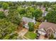 Aerial view of a brick home, with driveway and surrounding landscaping at 1355 Pinebreeze Way, Marietta, GA 30062
