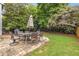 Backyard patio featuring a stone patio with a table and chairs, surrounded by a fenced yard at 1355 Pinebreeze Way, Marietta, GA 30062