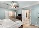 Comfortable bedroom featuring soft blue walls, a ceiling fan and multiple doors at 1355 Pinebreeze Way, Marietta, GA 30062