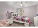 Cozy bedroom featuring a colorful bedspread, white furniture, and soft decor at 1355 Pinebreeze Way, Marietta, GA 30062