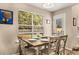 Cozy dining area featuring a wooden table set for four and a bright window view at 1355 Pinebreeze Way, Marietta, GA 30062