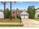Charming two-story brick home features a manicured front yard, mature trees, and a two-car garage at 1355 Pinebreeze Way, Marietta, GA 30062