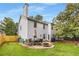 Exterior view of home with a stone patio, table, chairs, firepit and fenced backyard at 1355 Pinebreeze Way, Marietta, GA 30062