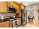 Modern kitchen featuring stainless steel appliances and adjacent dining area at 1355 Pinebreeze Way, Marietta, GA 30062
