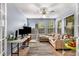 Comfortable living space with plush sofa, ceiling fan, and natural light from three windows at 1355 Pinebreeze Way, Marietta, GA 30062