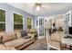 Inviting living space featuring a plush sofa, ample windows, and seamless flow to dining area at 1355 Pinebreeze Way, Marietta, GA 30062