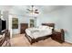 Tranquil main bedroom features a tray ceiling, ceiling fan, and ample natural light at 1355 Pinebreeze Way, Marietta, GA 30062