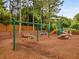 Community playground with swings, a slide, and picnic tables surrounded by lush trees at 1355 Pinebreeze Way, Marietta, GA 30062