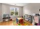 Bright room with a play kitchen, shelves filled with toys, and a colorful alphabet rug at 1355 Pinebreeze Way, Marietta, GA 30062