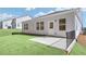 Backyard with a small concrete patio, manicured lawn, and well-maintained exterior at 189 Park Ln, Fairburn, GA 30213