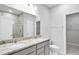 Elegant bathroom features dual sinks with granite countertops and a large vanity mirror at 189 Park Ln, Fairburn, GA 30213
