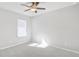 Bright bedroom features neutral tones, a ceiling fan, and a large window with natural light at 189 Park Ln, Fairburn, GA 30213