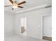 Open bedroom with a ceiling fan and an adjacent bathroom, creating a private and convenient space at 189 Park Ln, Fairburn, GA 30213