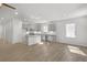 Open floor plan featuring kitchen with island, stainless steel appliances and wooden floors at 189 Park Ln, Fairburn, GA 30213