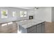 Kitchen island plus bright and open living area with fireplace and rear door at 189 Park Ln, Fairburn, GA 30213