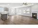 Open concept living area featuring fireplace, kitchen, and bright, natural light at 189 Park Ln, Fairburn, GA 30213