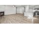 Open floor plan featuring kitchen, gas fireplace and light wood floors at 189 Park Ln, Fairburn, GA 30213