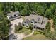 A serene aerial view of the home nestled among mature trees, highlighting its large lot and detached three-car garage at 193 Stonegate Trl, Carrollton, GA 30116