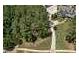 Aerial view of landscaped yard with a waterfall feature flowing into a small stream lined with rock at 193 Stonegate Trl, Carrollton, GA 30116