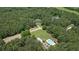 An aerial view highlighting property, pool, additional lots surrounded by woods at 193 Stonegate Trl, Carrollton, GA 30116