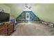 Attic bonus room with built in shelving, neutral carpet, television and ceiling fan at 193 Stonegate Trl, Carrollton, GA 30116