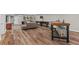 Finished basement with hardwood floors, featuring a wet bar, shuffleboard, and comfortable seating area at 193 Stonegate Trl, Carrollton, GA 30116