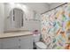 Cozy bathroom with mermaid themed shower curtain, bright natural lighting and round mirror at 193 Stonegate Trl, Carrollton, GA 30116