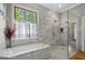 Luxurious bathroom with glass walk-in shower and sleek gray stone walls at 193 Stonegate Trl, Carrollton, GA 30116