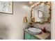 Charming powder room featuring an ornate mirror, vessel sink, and stylish vanity at 193 Stonegate Trl, Carrollton, GA 30116