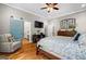 Bright bedroom with hardwood floors, a comfortable chair, and an ensuite bathroom for added convenience at 193 Stonegate Trl, Carrollton, GA 30116
