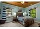 Bedroom with a wood ceiling, ceiling fan, windows, and a bed with a brown headboard at 193 Stonegate Trl, Carrollton, GA 30116