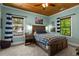 Comfortable bedroom with a wooden ceiling, natural light, and charming decor at 193 Stonegate Trl, Carrollton, GA 30116