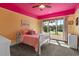 Bright bedroom with pink ceiling, a large window, and natural light at 193 Stonegate Trl, Carrollton, GA 30116